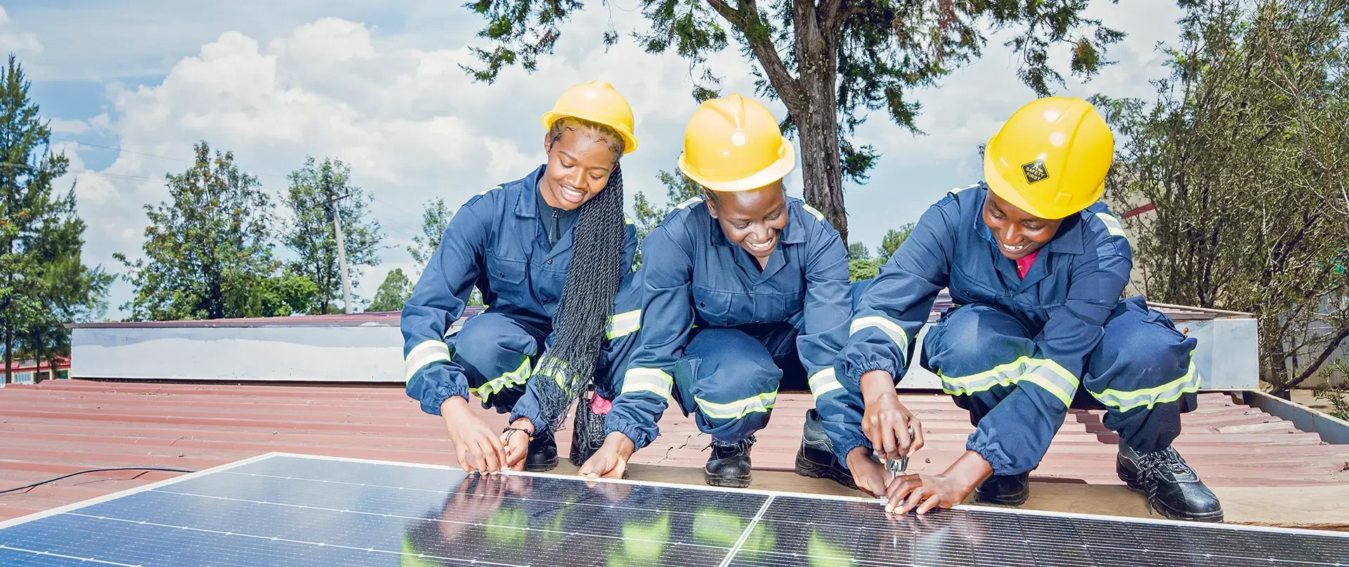 Students in safety gear installing a solar panel during a WTS Foundation technical course